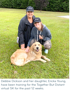 two women in workout clothes posing with a dog